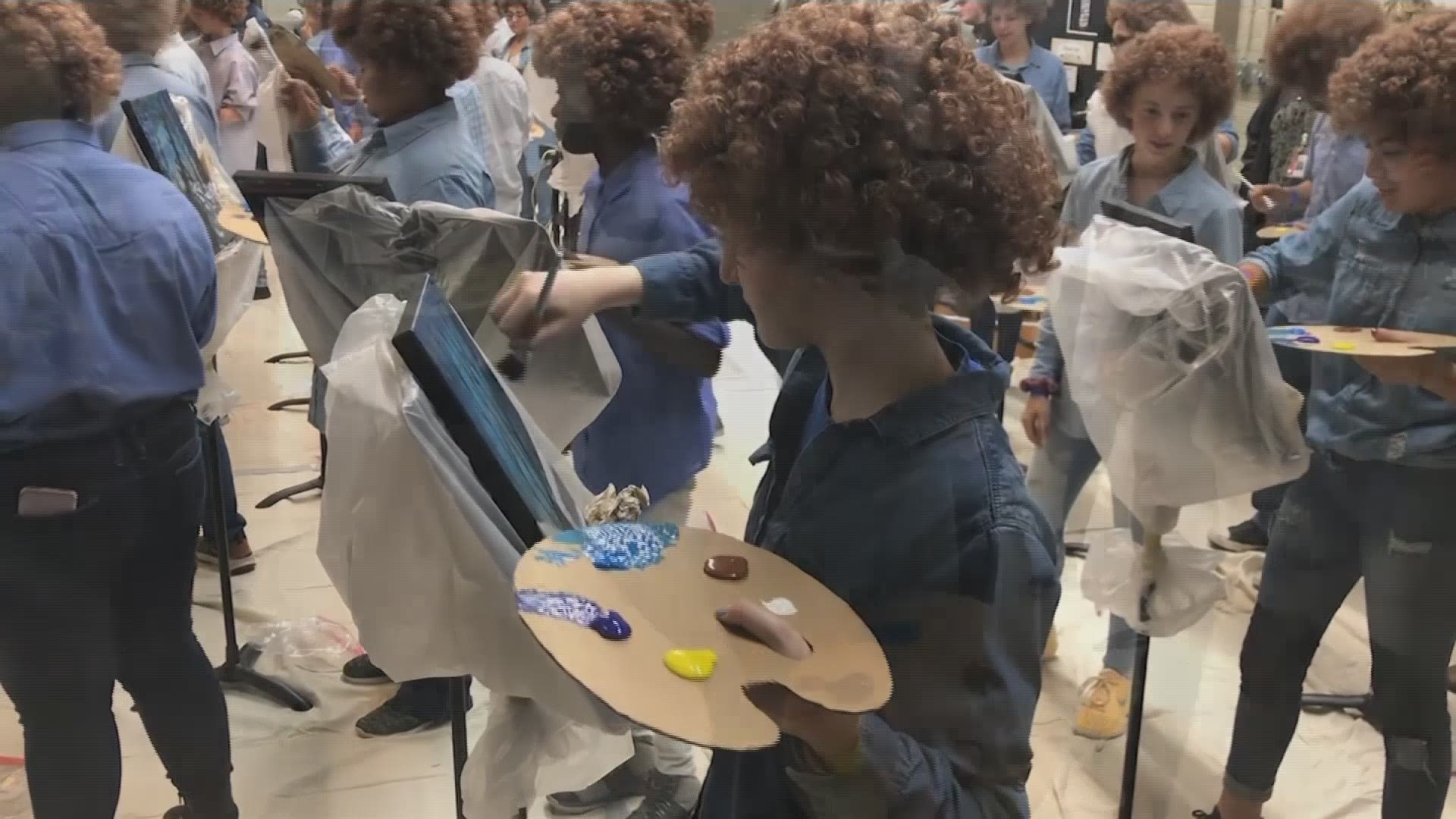 Art students put on their curliest wigs and painted little trees onto canvases to pay homage to the late painter Bob Ross. (Timothy Chipp/Abilene Reporter-News)