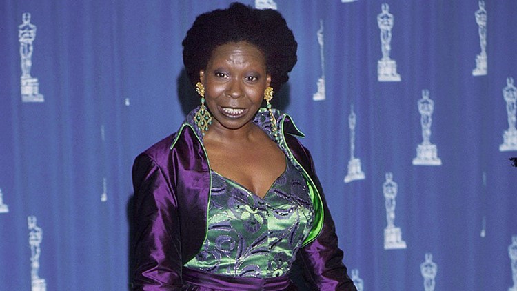 whoopi goldberg purple dress Whoopi Goldberg was lambasted for her 1993 Oscars look, a lime green and purple brocade jumpsuit with fitted pants, worn under a sweeping deep purple satin coat with a high-low skirt effect