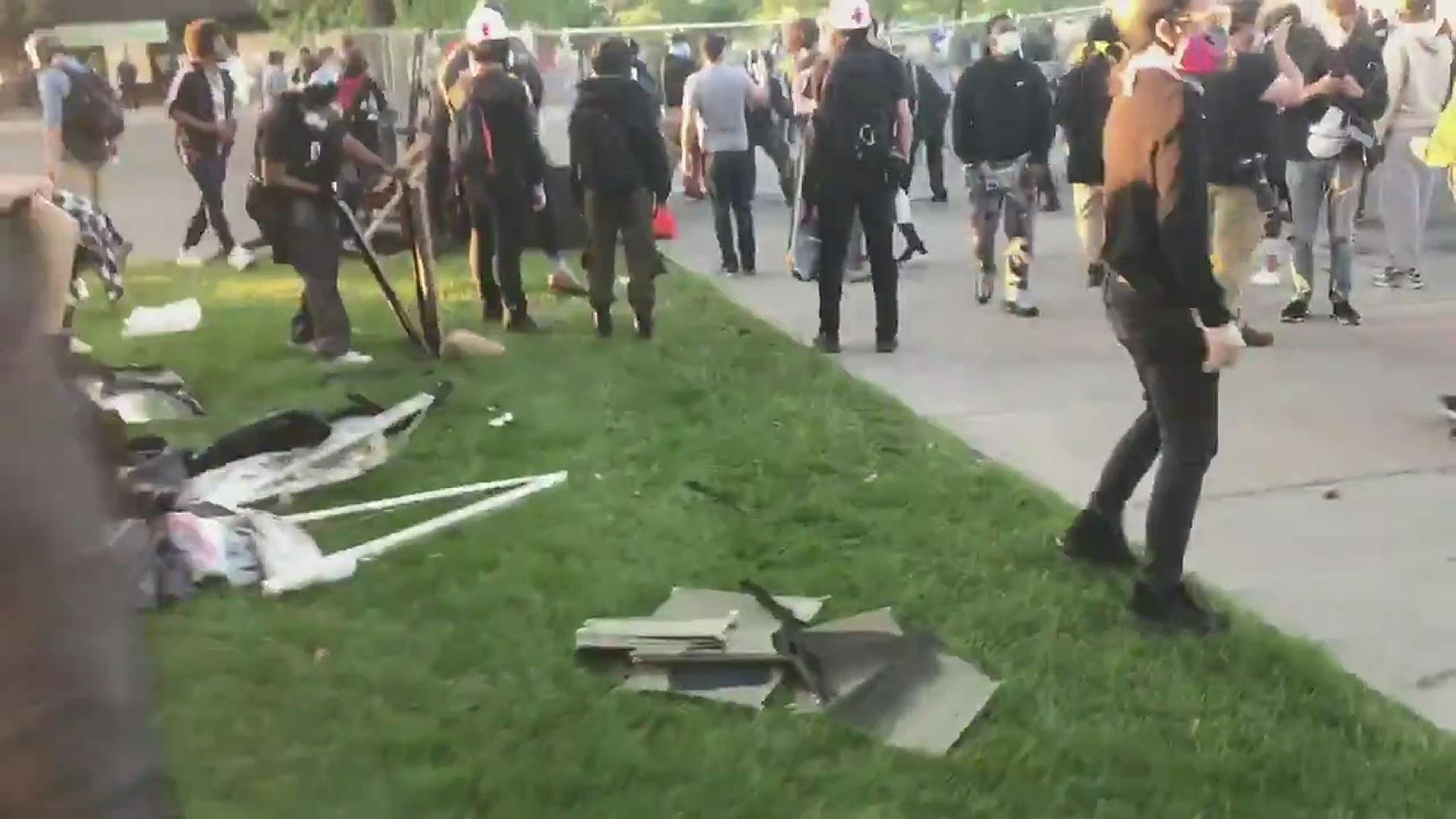 Protesters prepare barricades on Nicollet Avenue with the media and bystanders nearby on May 30, 2020.