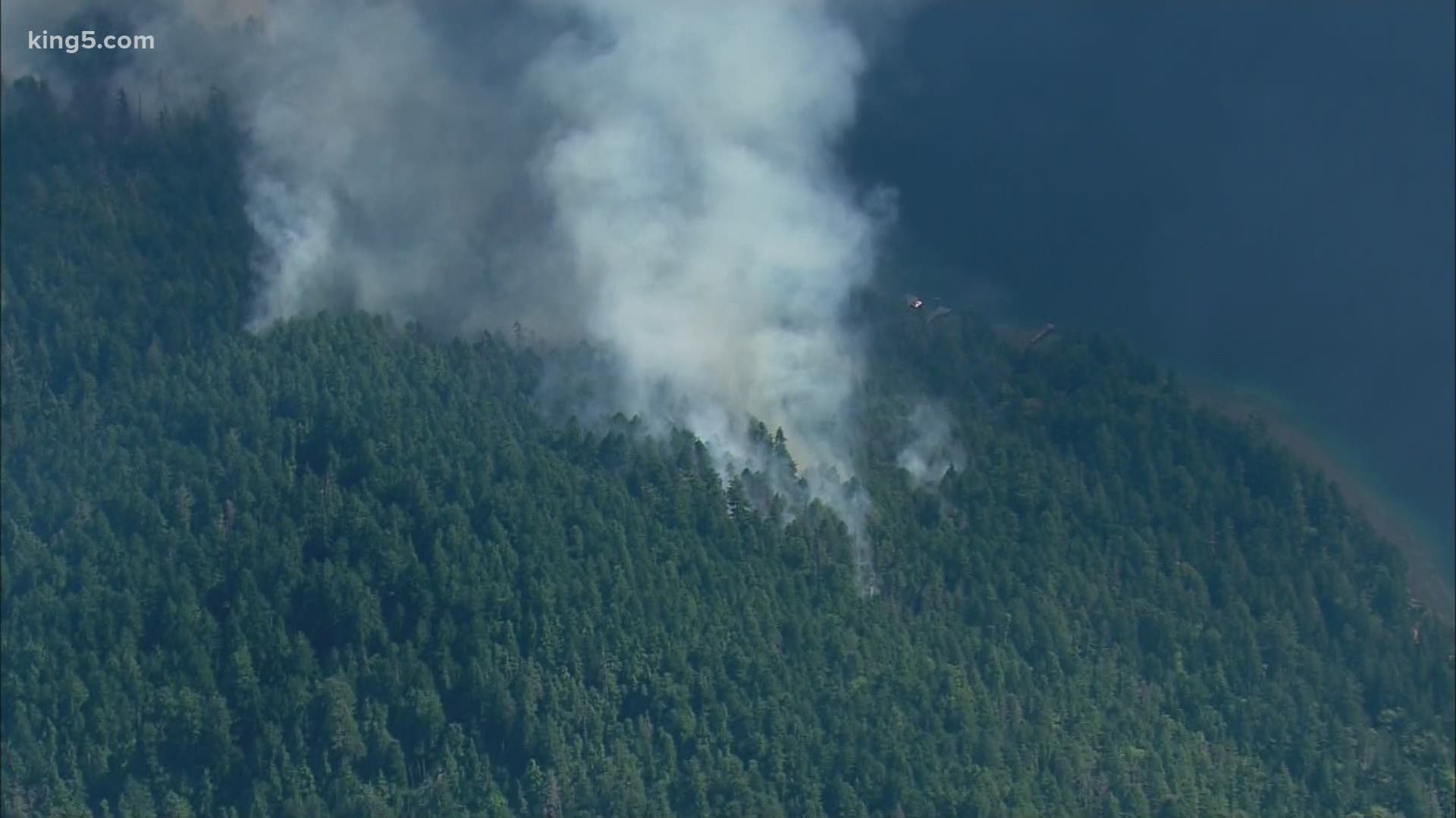 As crews battle a 200-acre fire in Douglas county another 65-acre fire rages on the west side of the Cascades near Lake Crescent on the Olympic Peninsula.