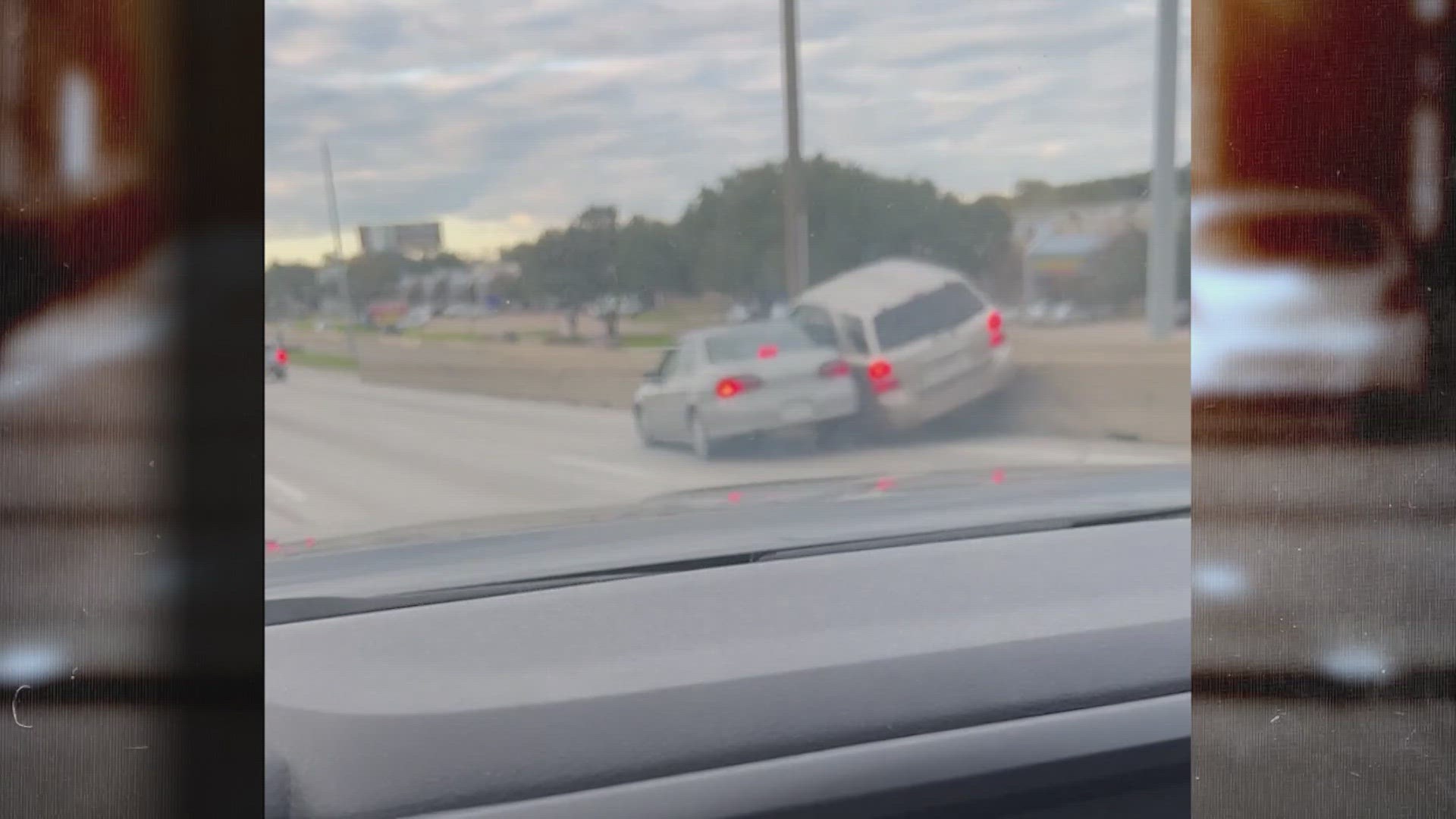 After throwing drinks at each other, one of the car's pushed the other into the concrete barrier along I-35.