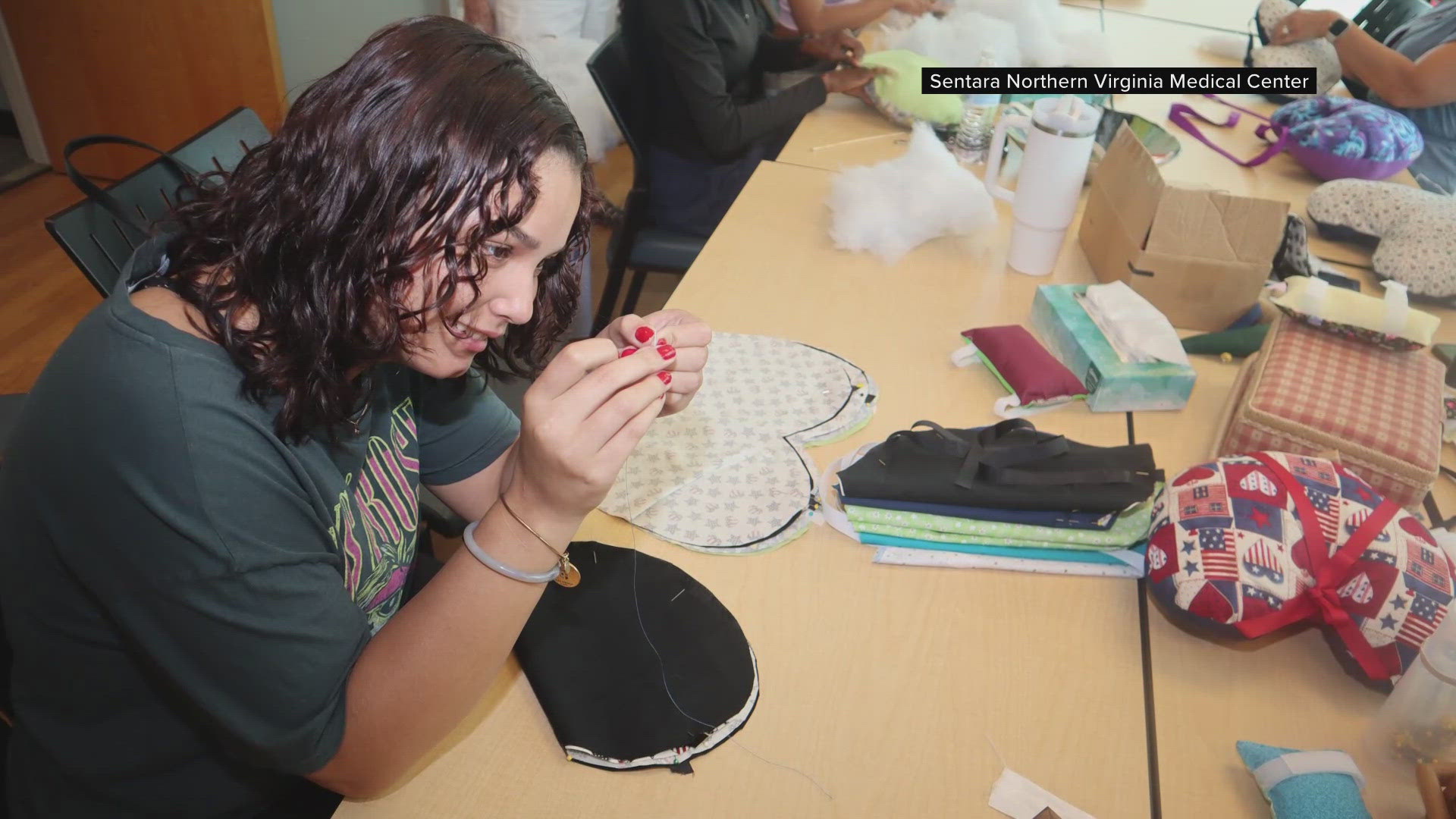 Volunteers sew heart-shaped pillows for cancer patients at the Sentara Cancer Network Resource Center in Woodbridge.