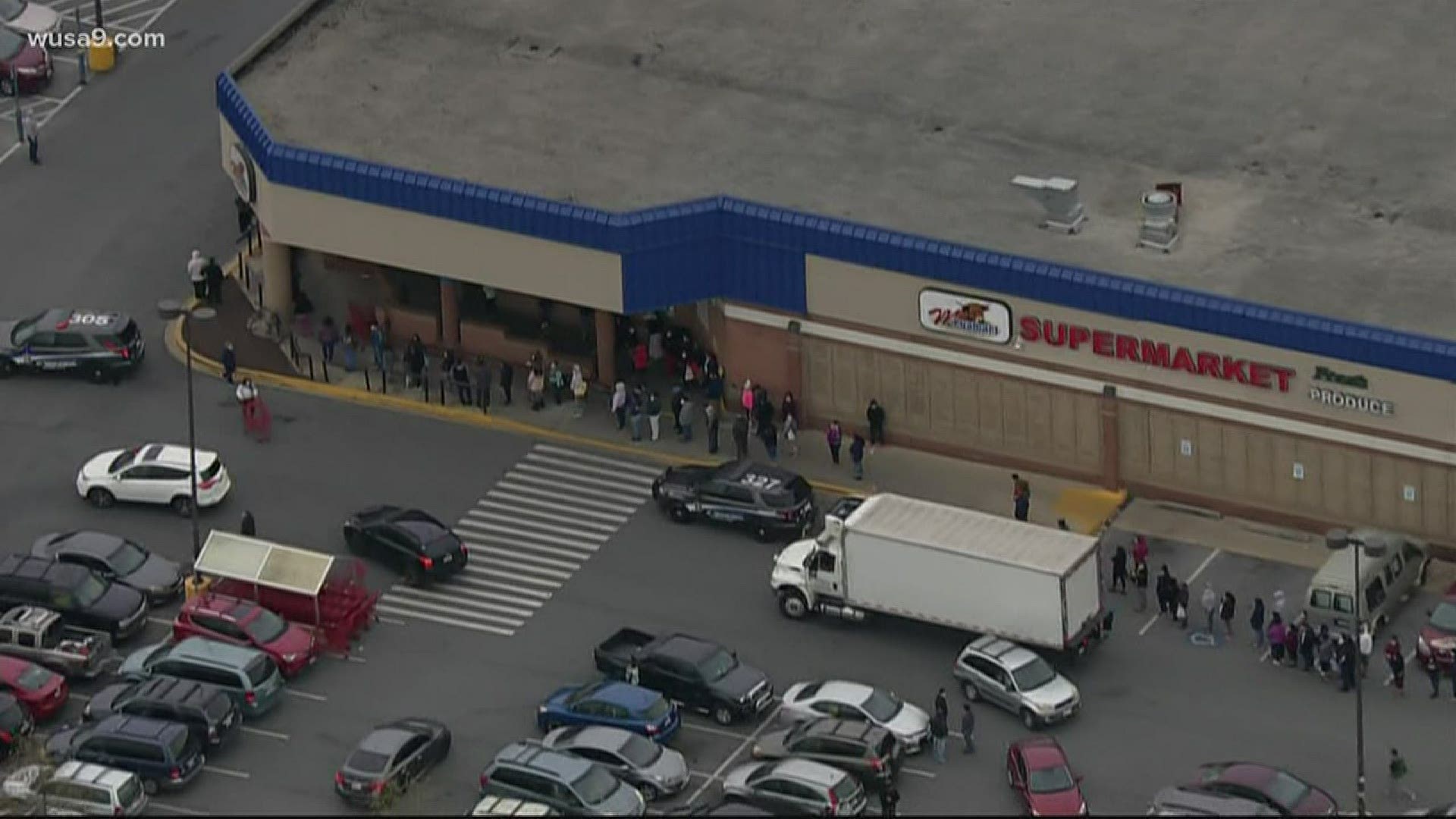Dozens of people lined up for a grocery giveaway, with a seeming disregard for social distancing guidelines