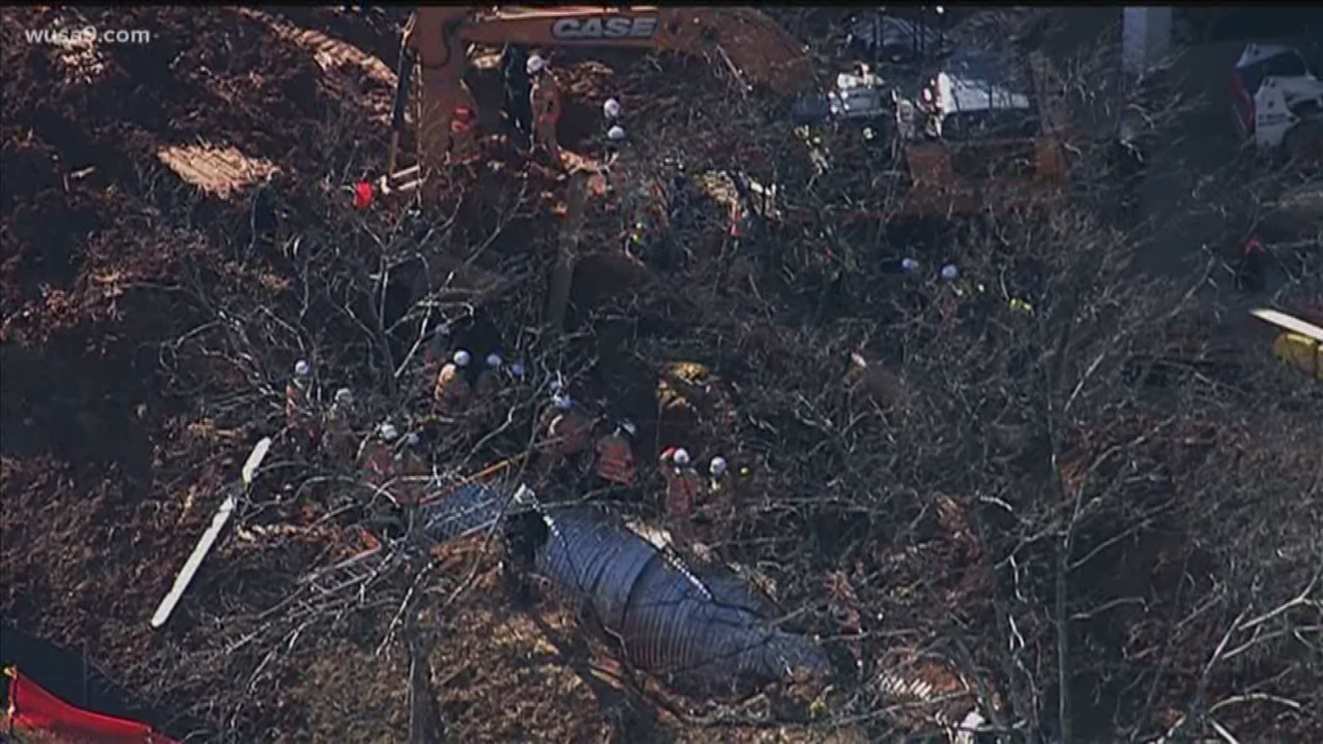The man was trapped up to his chest in the trench, officials say.
