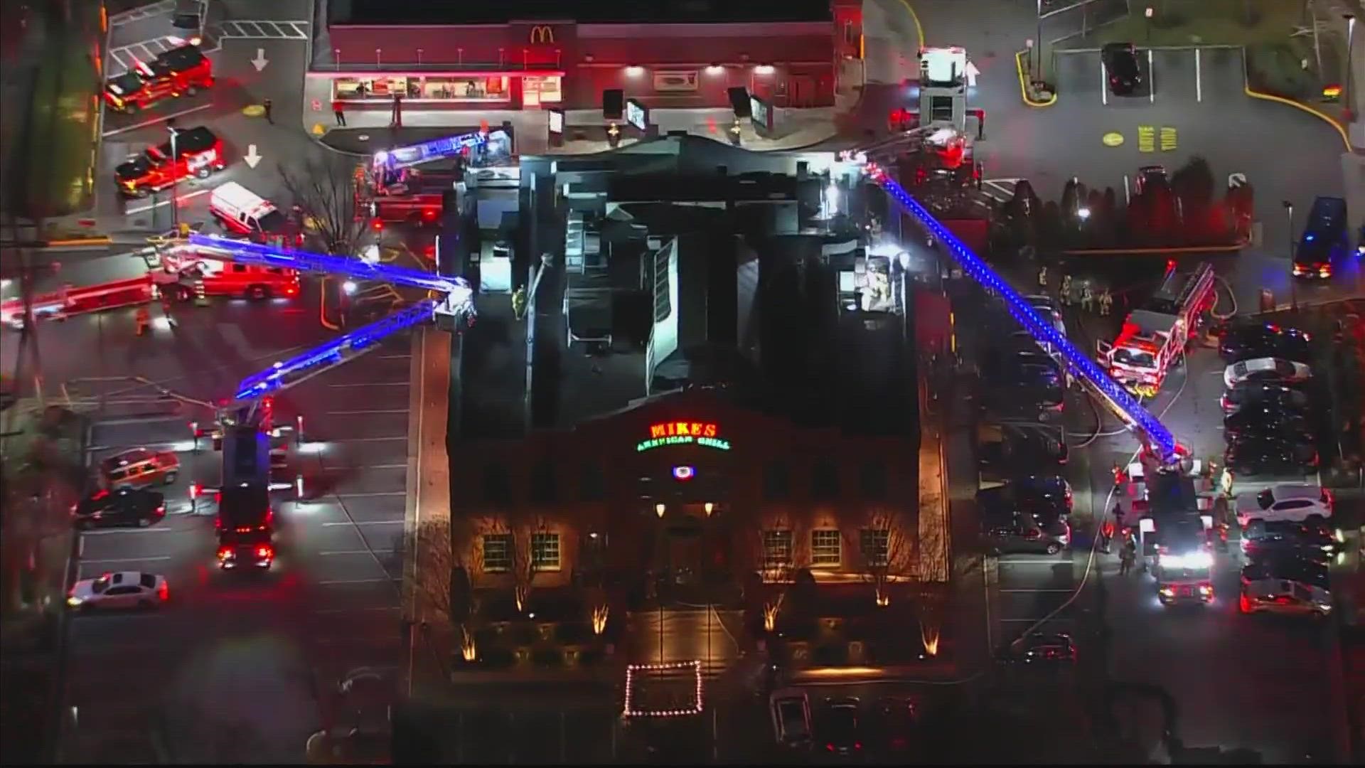 The fire forced couples celebrating Valentine's Day at Mike's American Grill out onto the street as the fire burned up to the roof of the building.