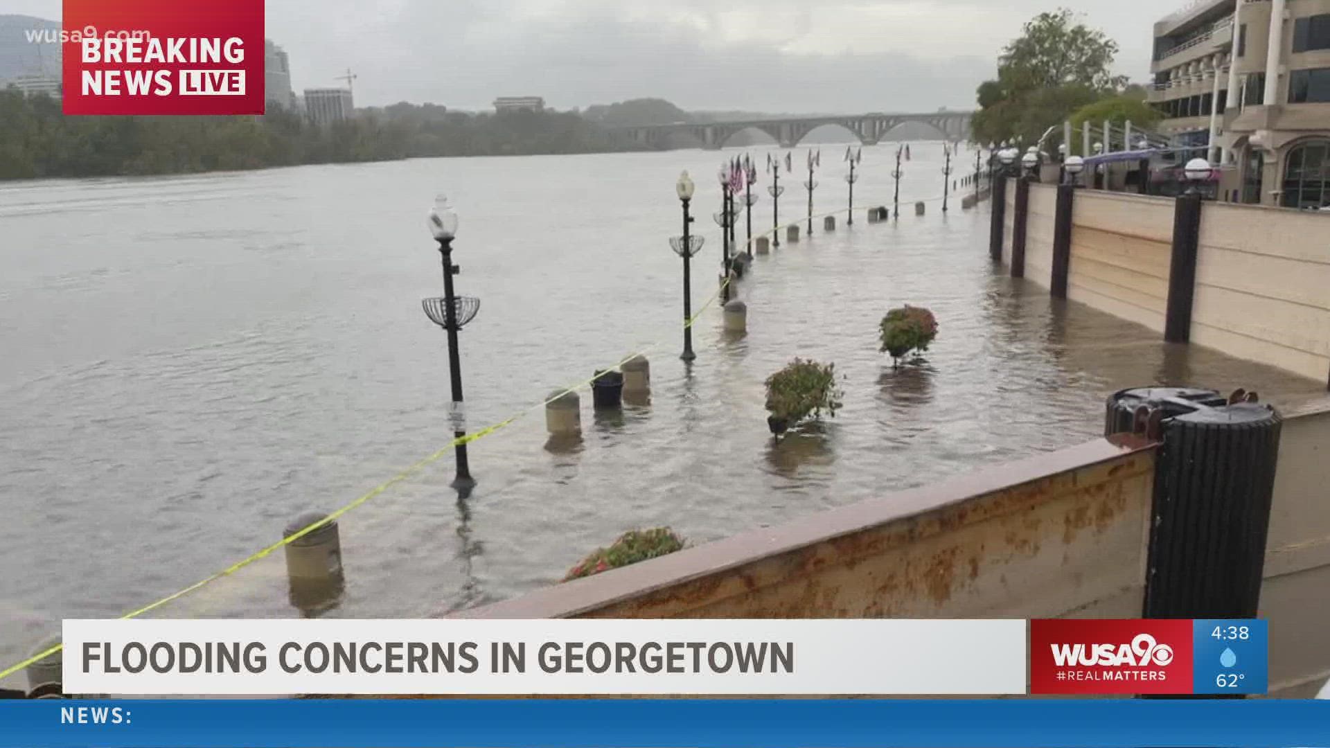 The flood wall prevents businesses in Georgetown, D.C., from experiencing flooding as heavy rain flows and the tide rises.