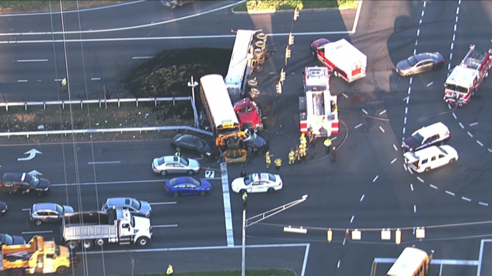 One person is dead and at least nine others have been evaluated after crash involving a school bus, carrying students, and an overturned tractor-trailer Wednesday morning in Prince George's County, Maryland, officials said.