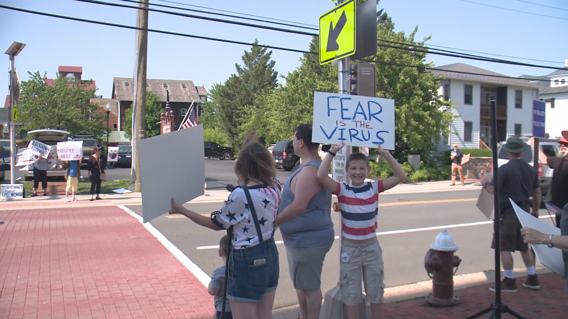 Protesters held signs outside the Loudoun County Government Center Friday