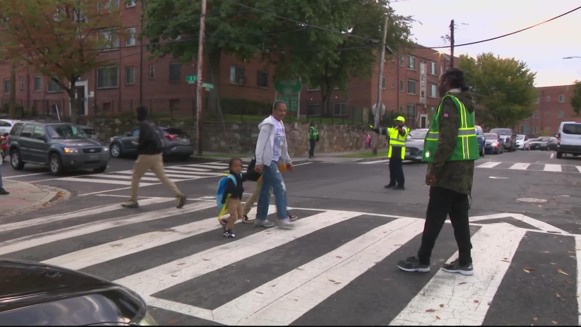 Safe Passage is a team of about 200 workers who stand in the intersection near schools in Washington D.C., to greet kids, get to know and keep them safe.