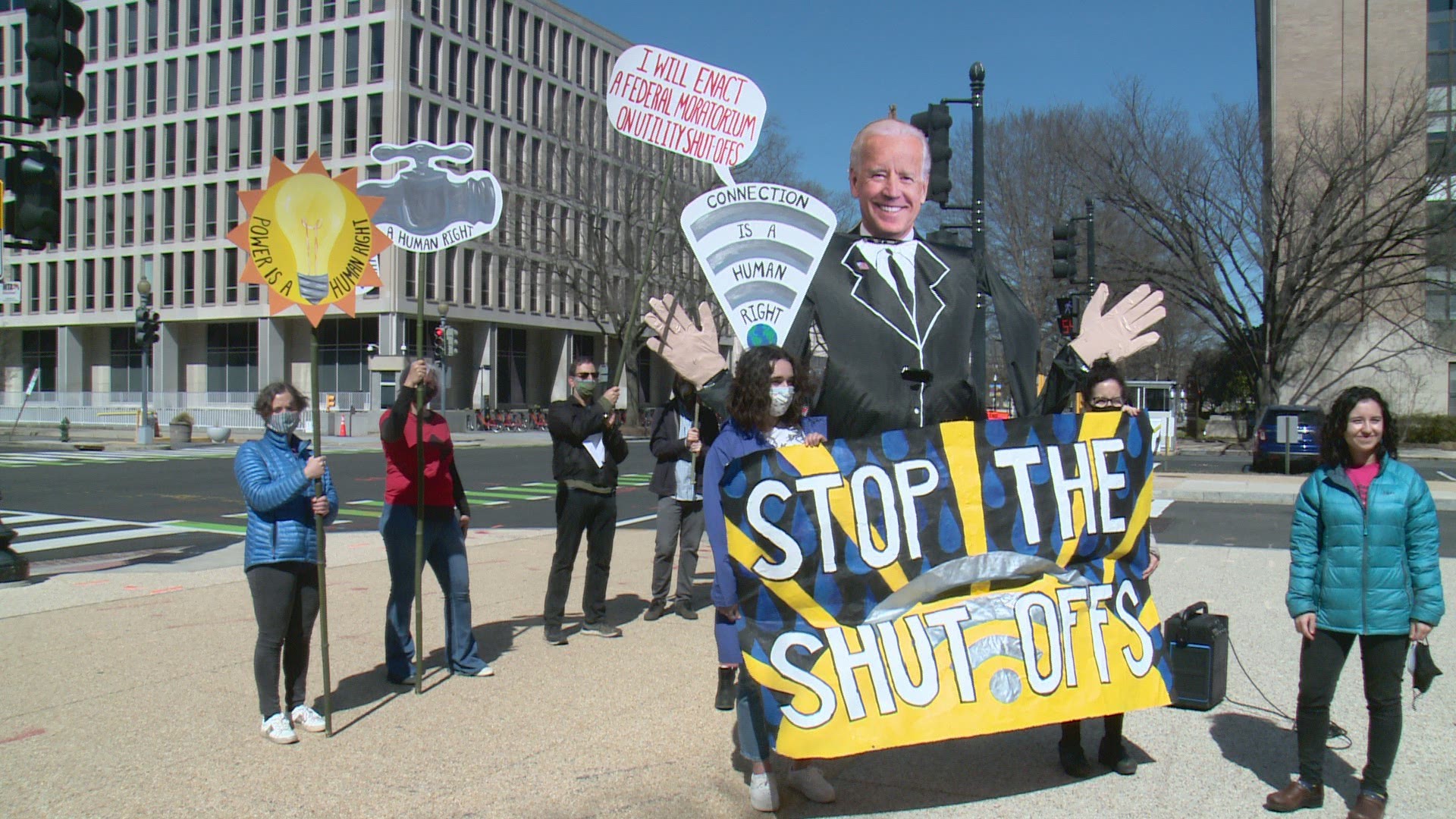 Signs were directed at President Joe Biden about utility shut-offs that have happened to people during the pandemic.
