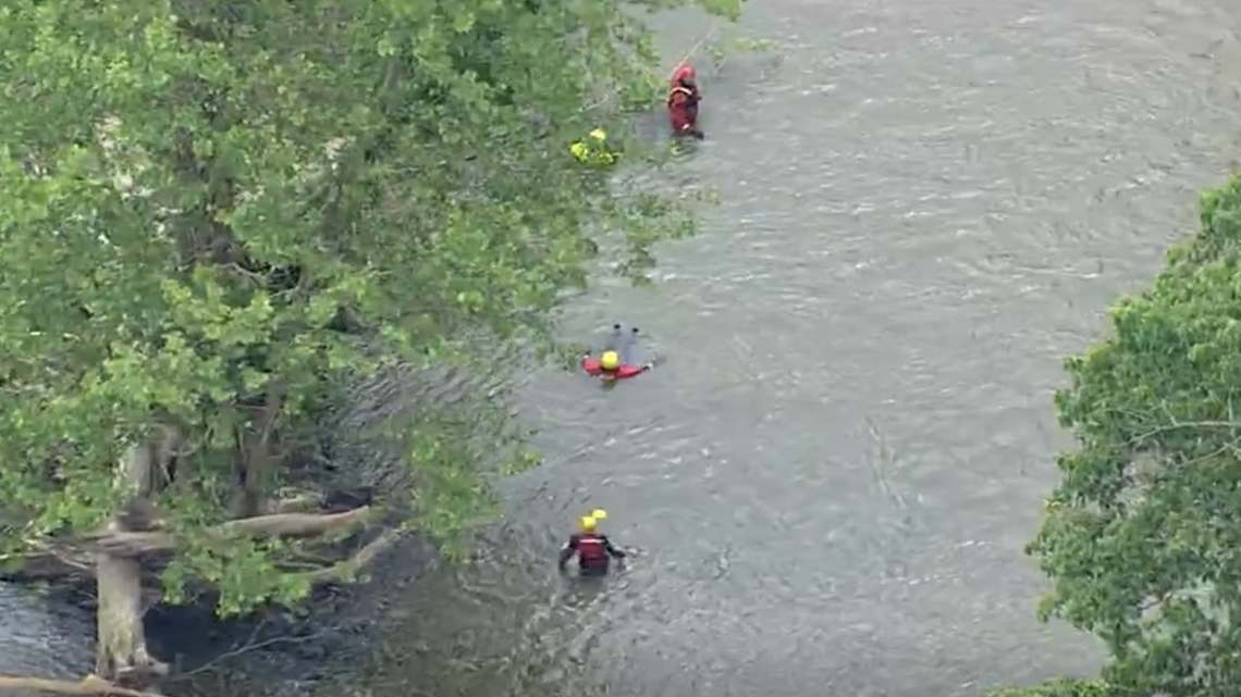 A kayaker was clinging on to rocks after being separated from his boat ...