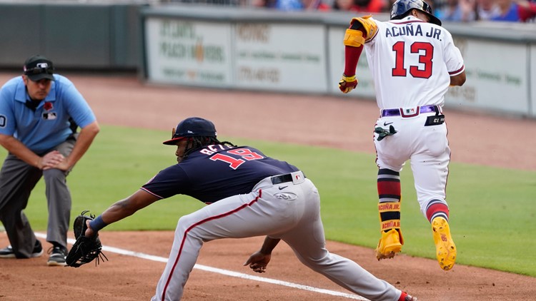 A giant United States flag is stretched across the outfield of