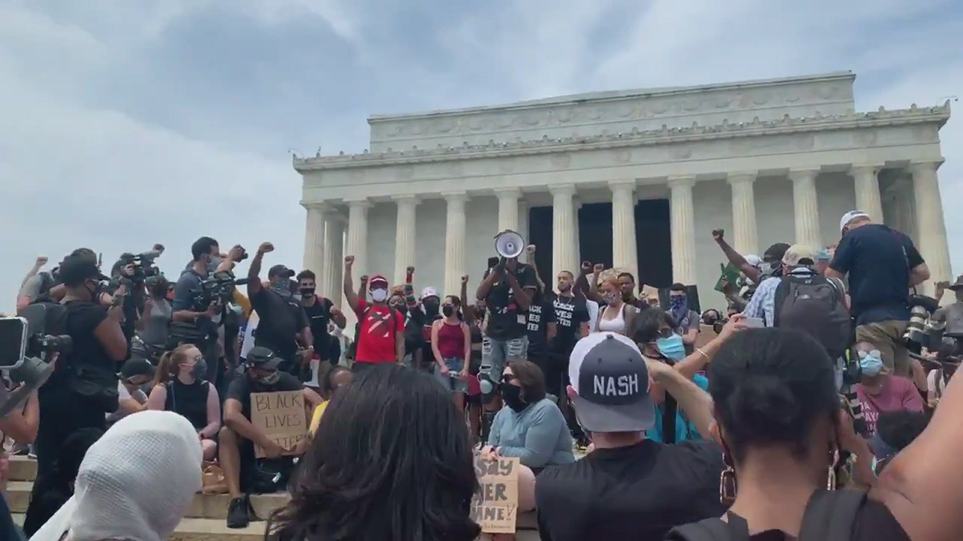 Protesters sing "Lift Every Voice and Sing" at the historic Lincoln Memorial in Washington, D.C.