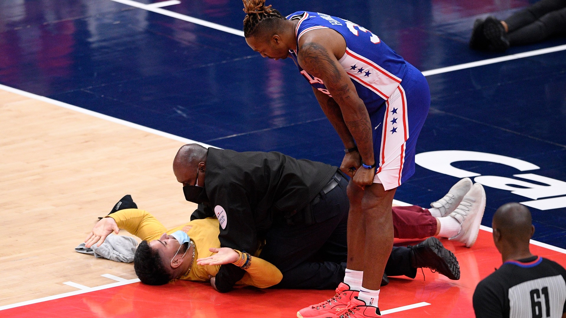 A fan was tackled as he tried to get on the court during an NBA playoff game between the Wizards and 76ers on Monday night.