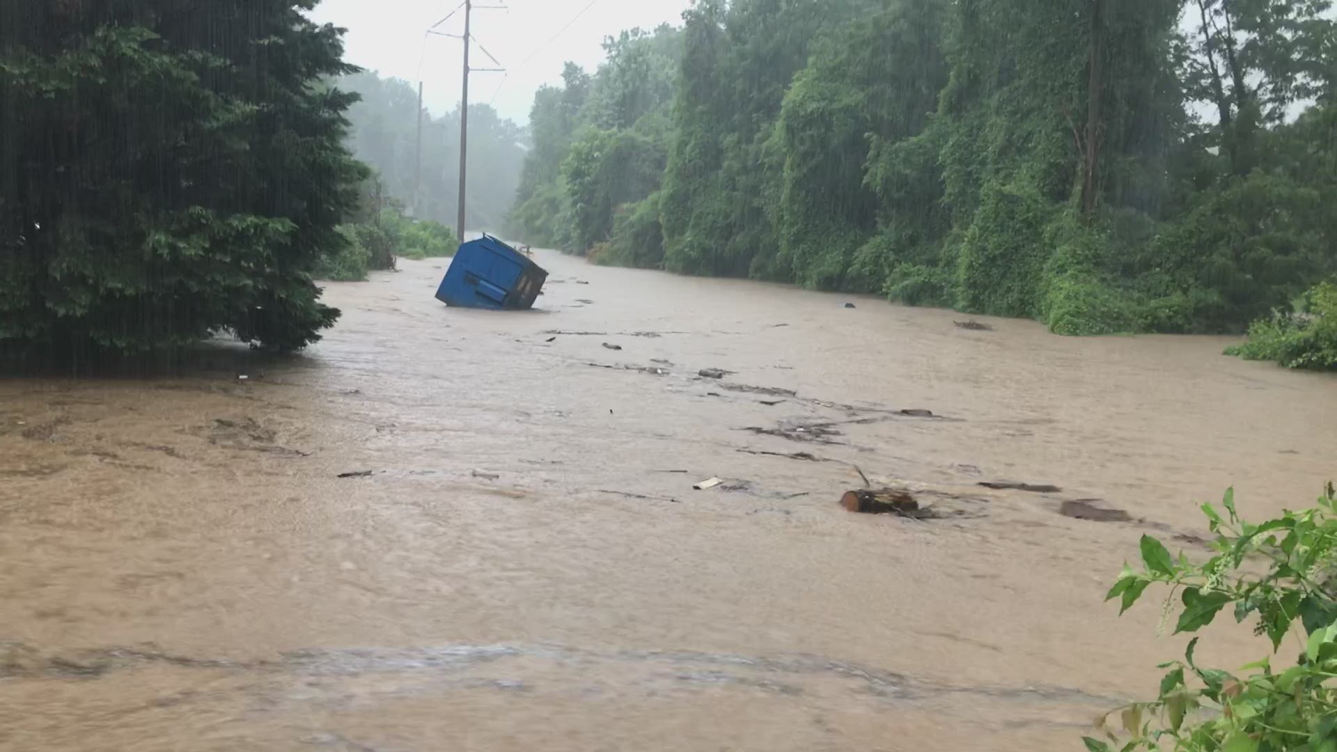A dumpster was carried away in flood waters in McLean, Virginia after heavy storms slammed into the DMV on Monday. Rain fell at a rate of three to four inches an hour.
