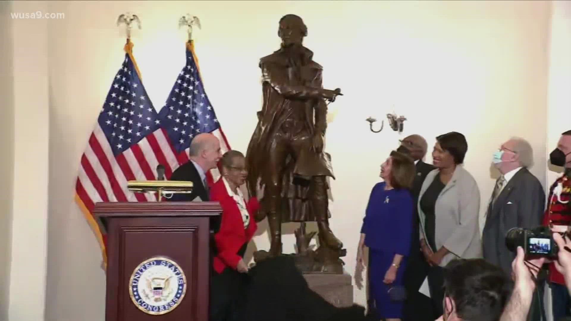 House Speaker Nancy Pelosi, Del Eleanor Holmes Norton, Mayor Muriel Bowser and other speak at the unveiling of a new statue of Pierre L'Enfant at the Capitol.
