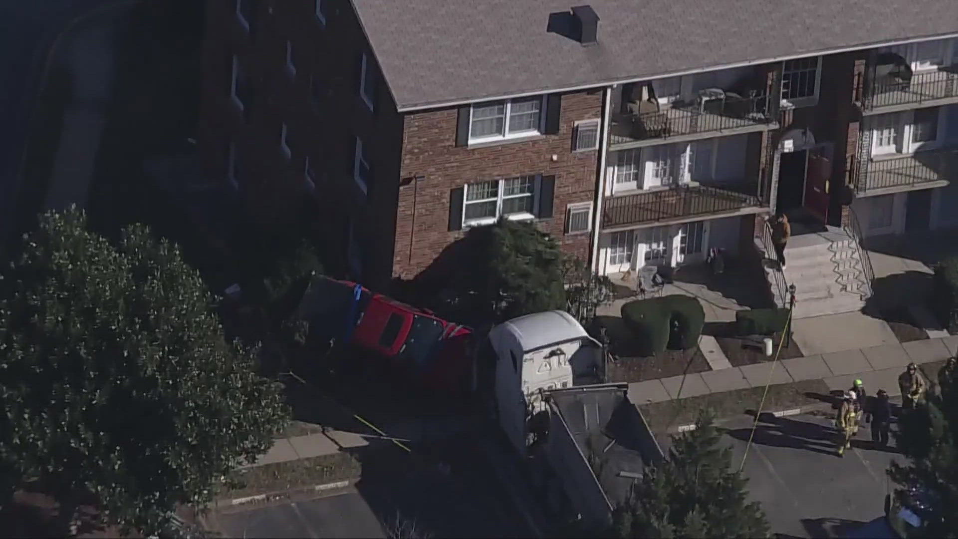 Four people are in the hospital and several people are without a place to live after a truck and a tractor-trailer struck a condo building in Woodbridge Monday.