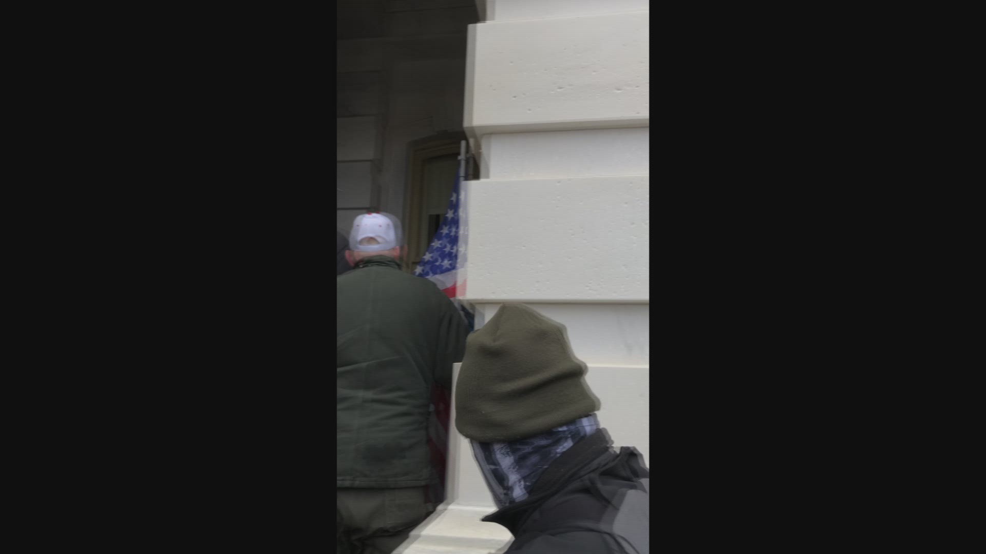 A new video released by Judge Royce Lamberth appears to show Jacob Chansley joining in with a mob entering the U.S. Capitol building on January 6.
