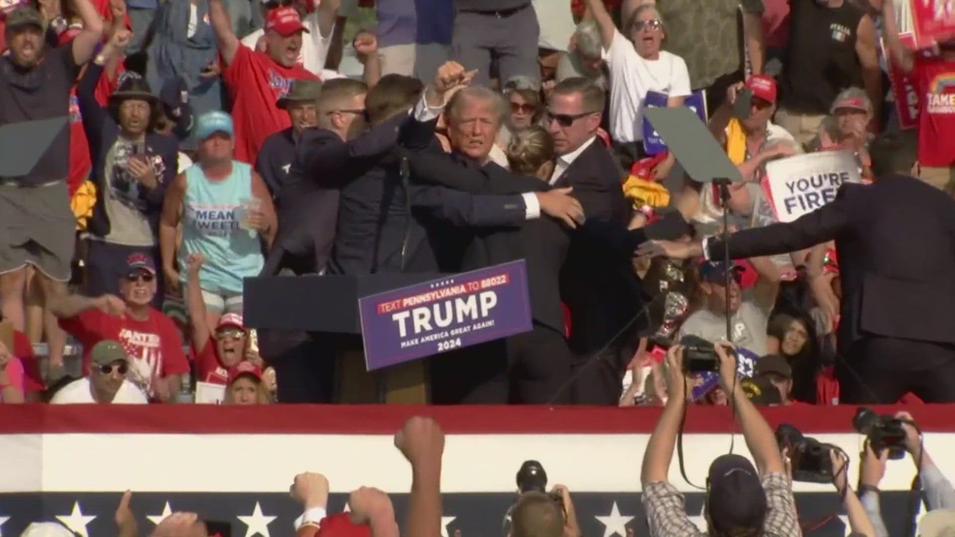 The former president raised his fist leaving the stage, and later wrote on social media that he was shot in the ear.