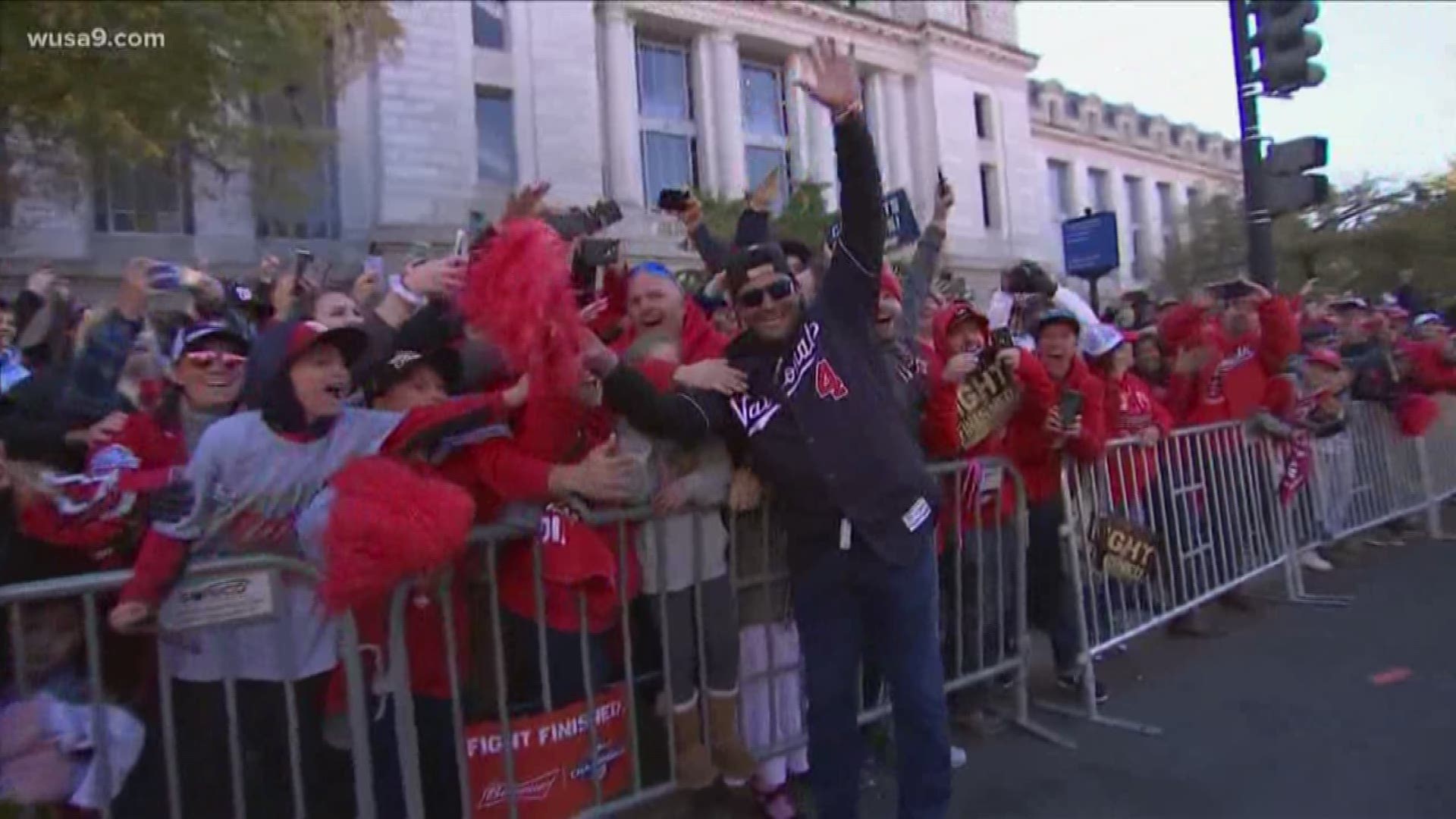 Washington Nationals manager, Davey Martinez celebrates with fans and Mike Rizzo allows fans to touch trophy