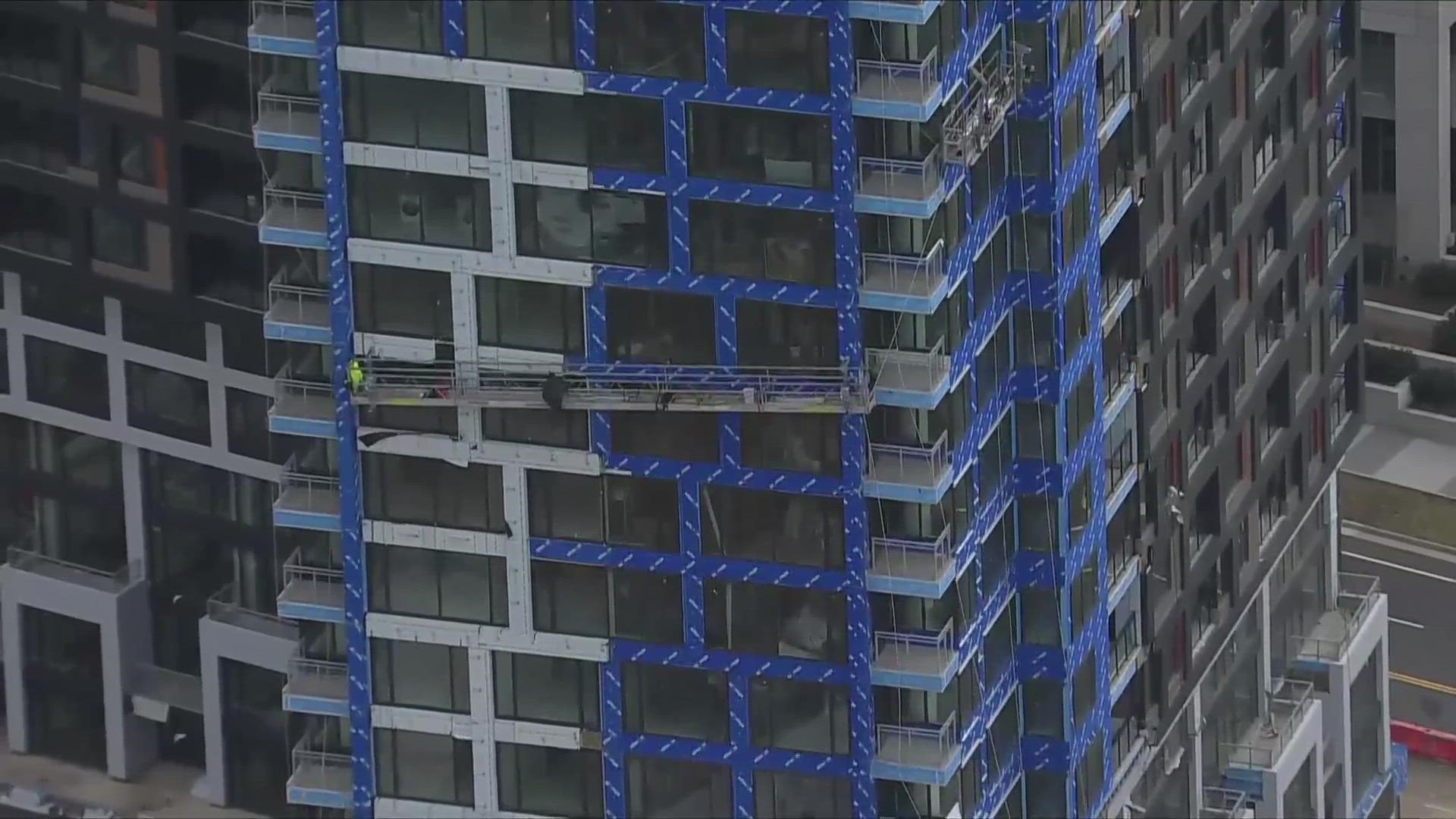 The worker fell just above scaffolding that was 13 stories in the air, according to firefighters.