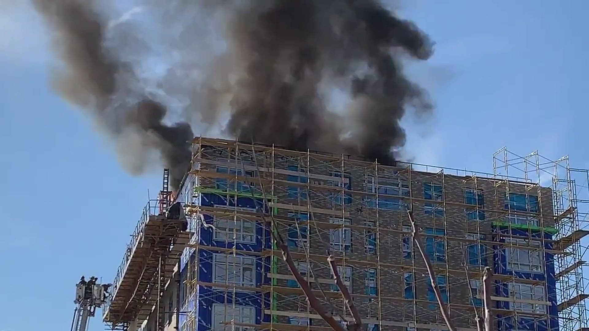 D.C. Fire & EMS officials say that heavy fire and smoke are coming from the roof of a multi-story building under construction.