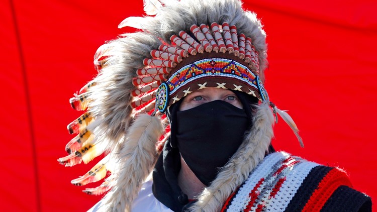 Chiefs fans wearing Native American headgear, doing Tomahawk Chop