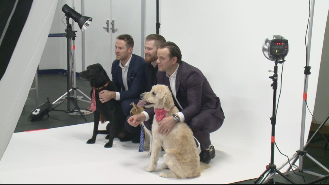 Washington Capitals players pose with puppies for a good cause