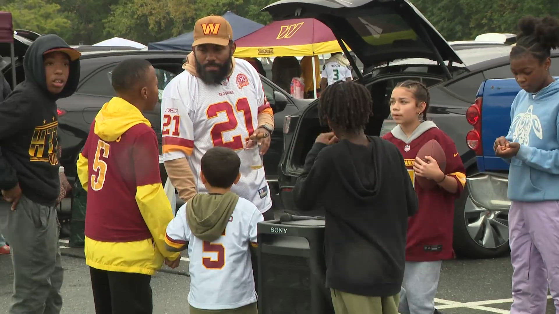 Commanders fans celebrate first win of season at rainy home opener ...