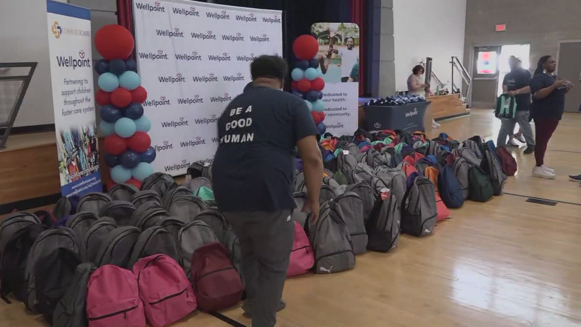 Dozens of people filled backpacks with items kids may need.