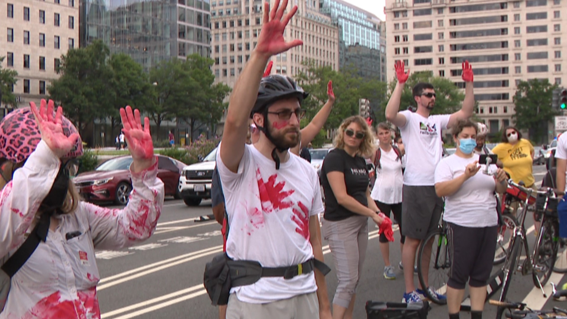 Dozens of bicycling and pedestrian advocates protested outside the Wilson Building.