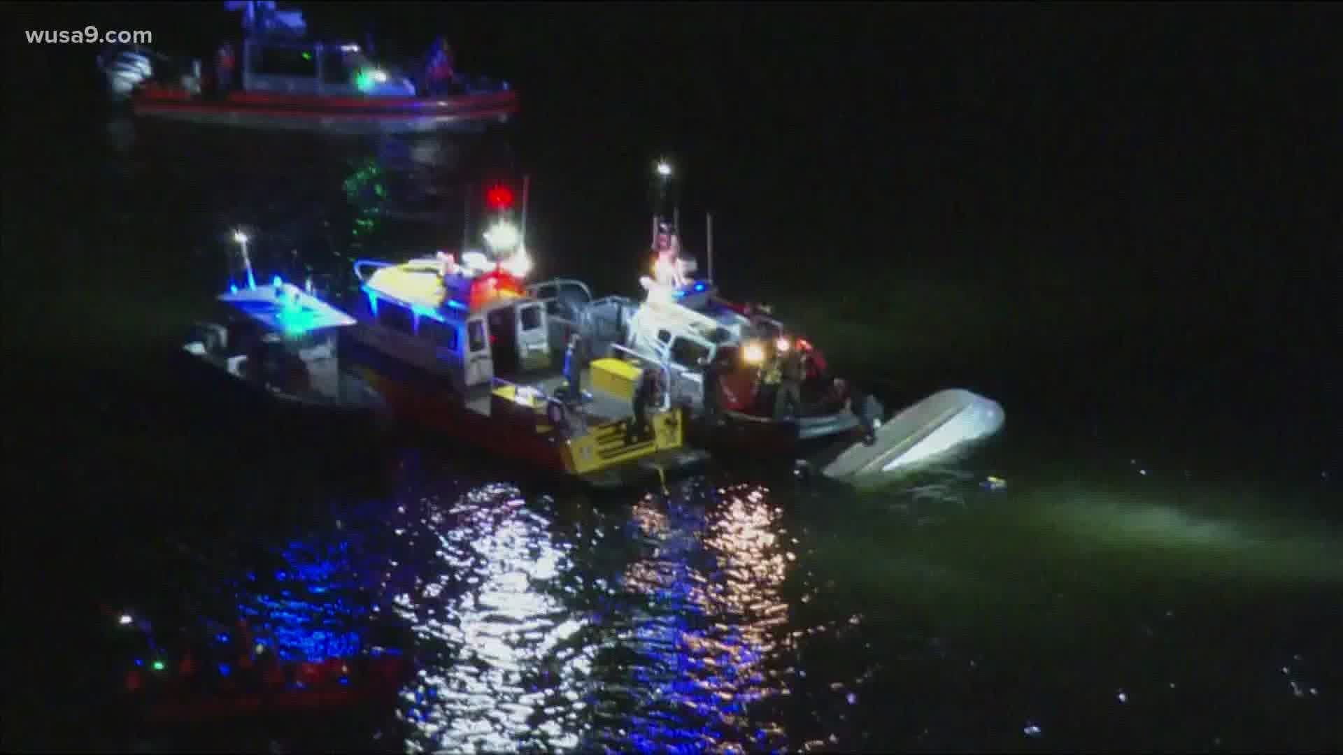 Four people have been rescued after their boat overturned near the Bay Bridge, officials say.