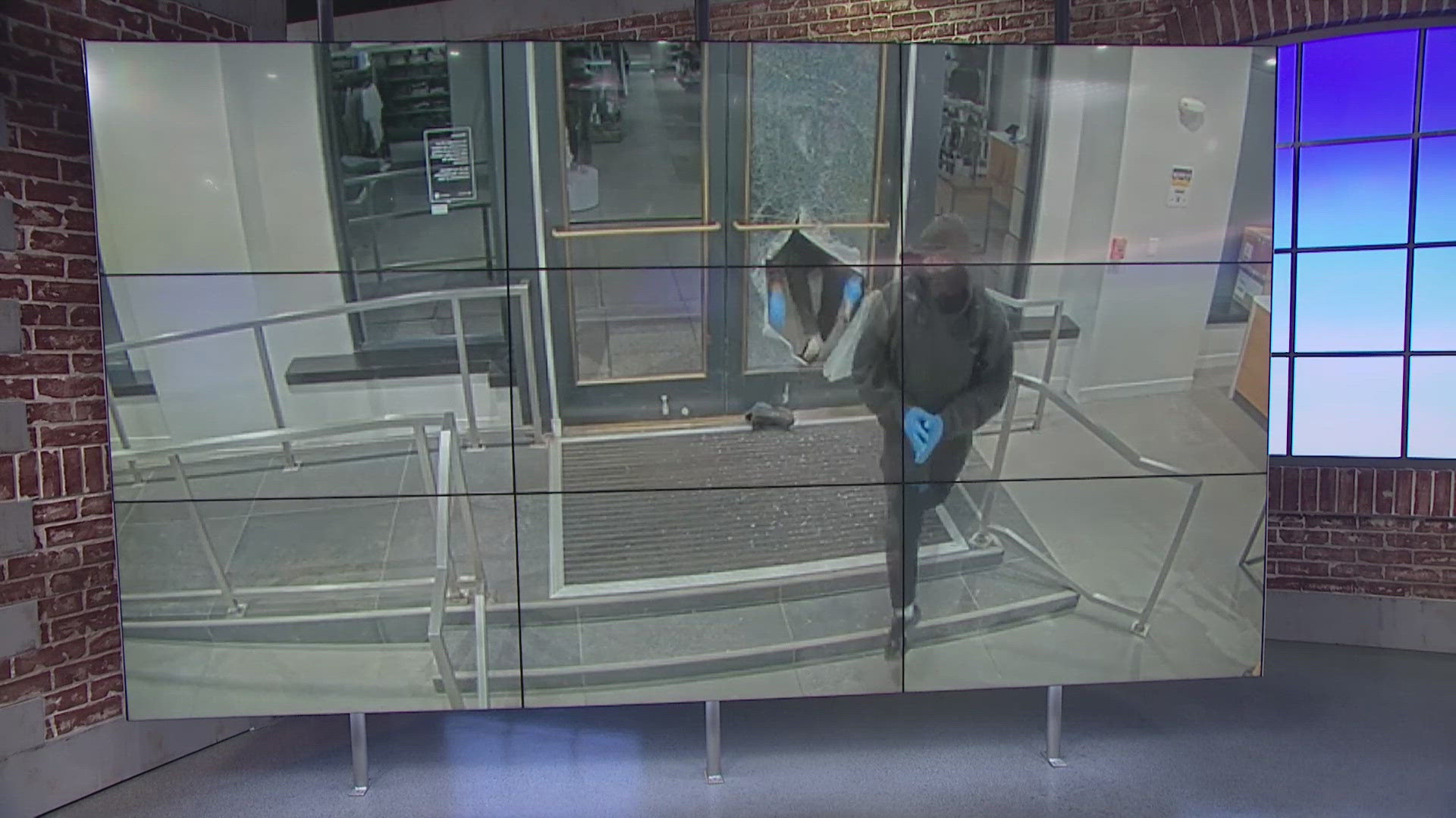 Surveillance video shared by MPD shows the suspects breaking through the glass on the clothing store's front entrance with a hammer.