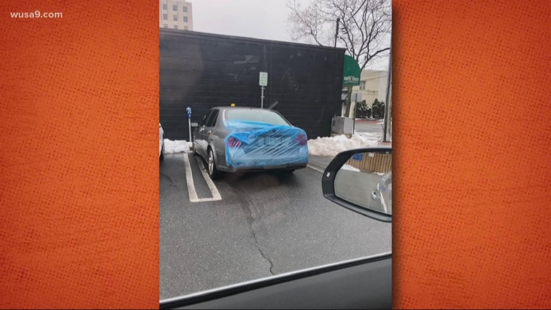 There's plastic covering a car. The obvious question.
What are they trying to protect? The license plate? Maybe they didn't pay meter.