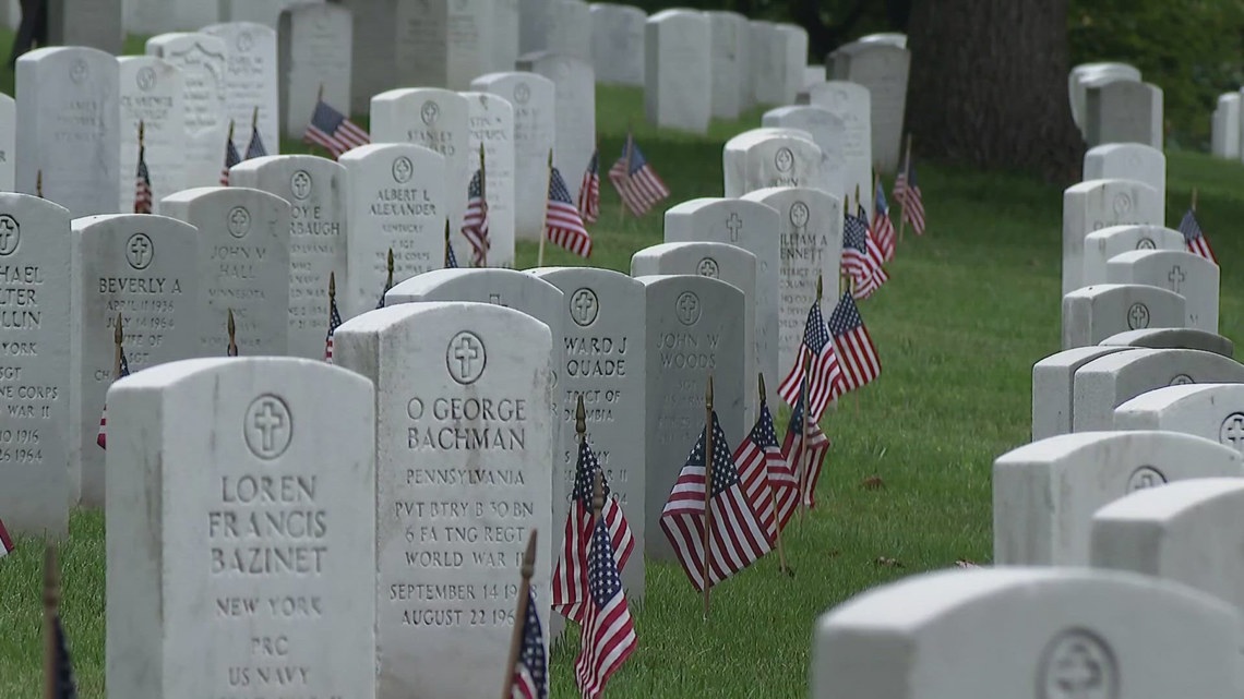 Military members place flags at headstones along Arlington National ...