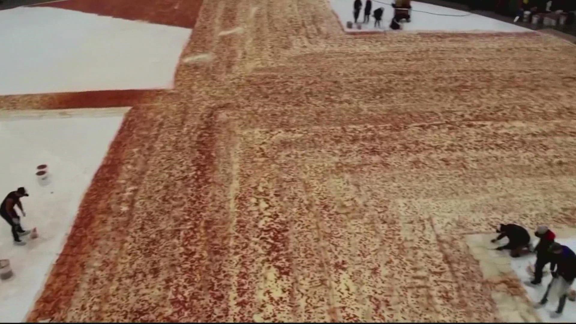 The pizza covers about 14-thousand square feet.  That's roughly 68-thousand slices. Pizza Hut organized all this - hoping to get into the record books.