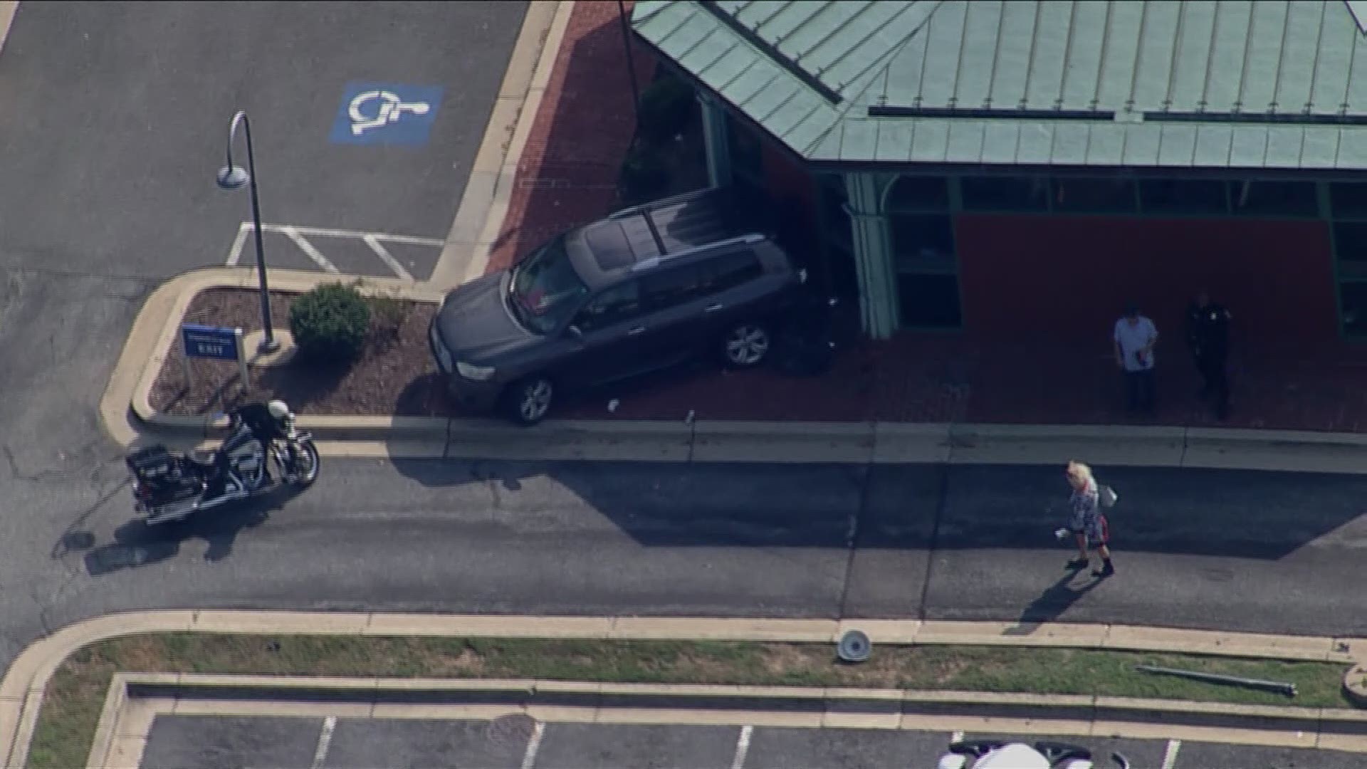 A car crashed into a Capital One Bank in Potomac. Police said the driver struck the front entrance and knocked down a light pole.