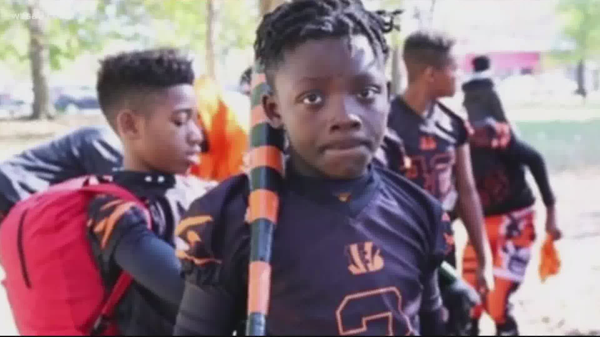 The group marched more than six miles from the football field where the 11-year-old played to the spot he was killed one week ago.