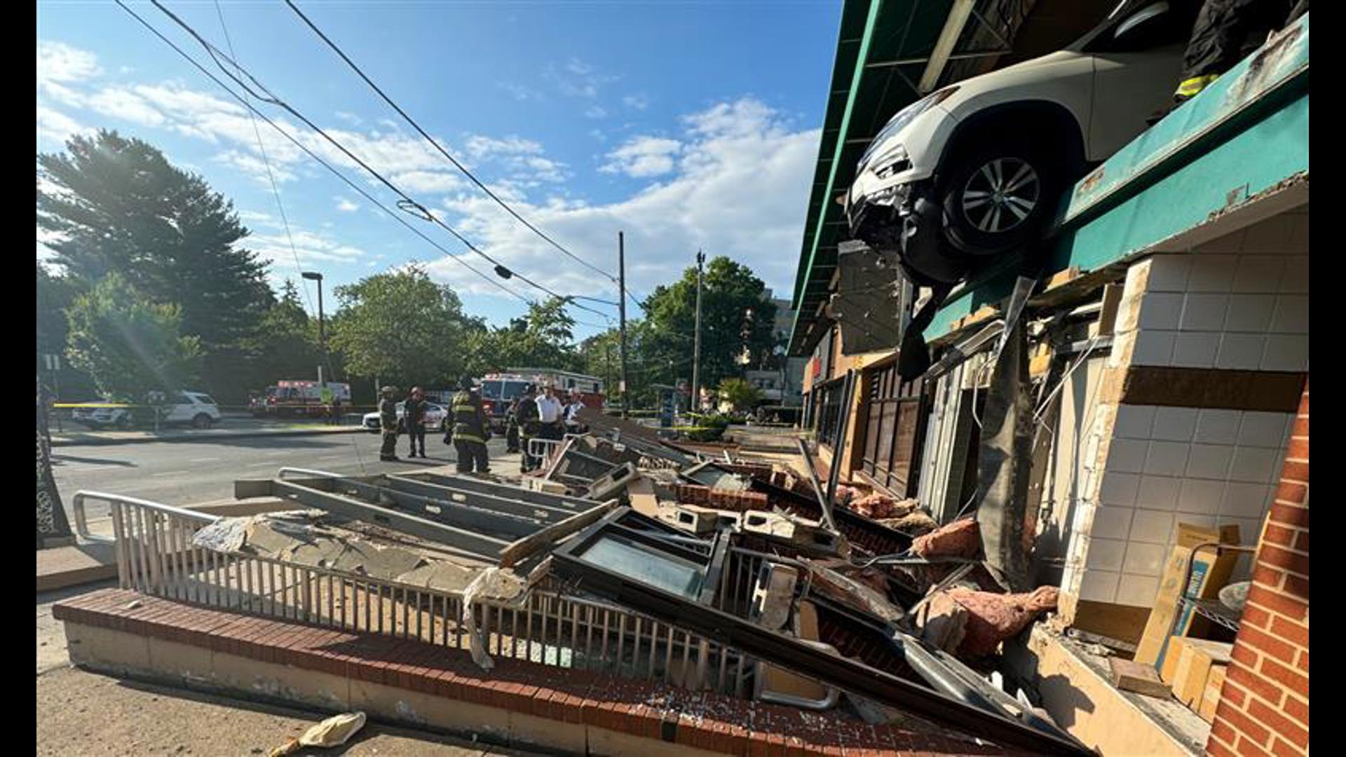 In a scene that left many onlookers stunned, a car was found dangling partially off the edge of the Whole Foods parking garage in Tenleytown early Thursday morning.