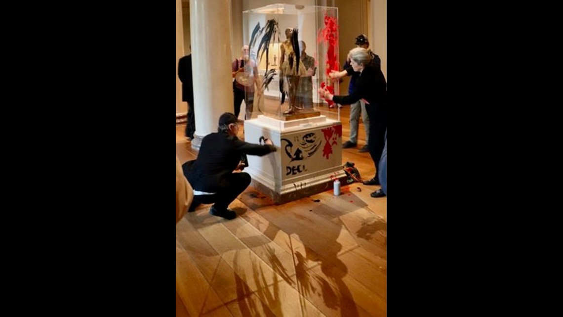 Demonstrators paint sculpture case at National Gallery of Art