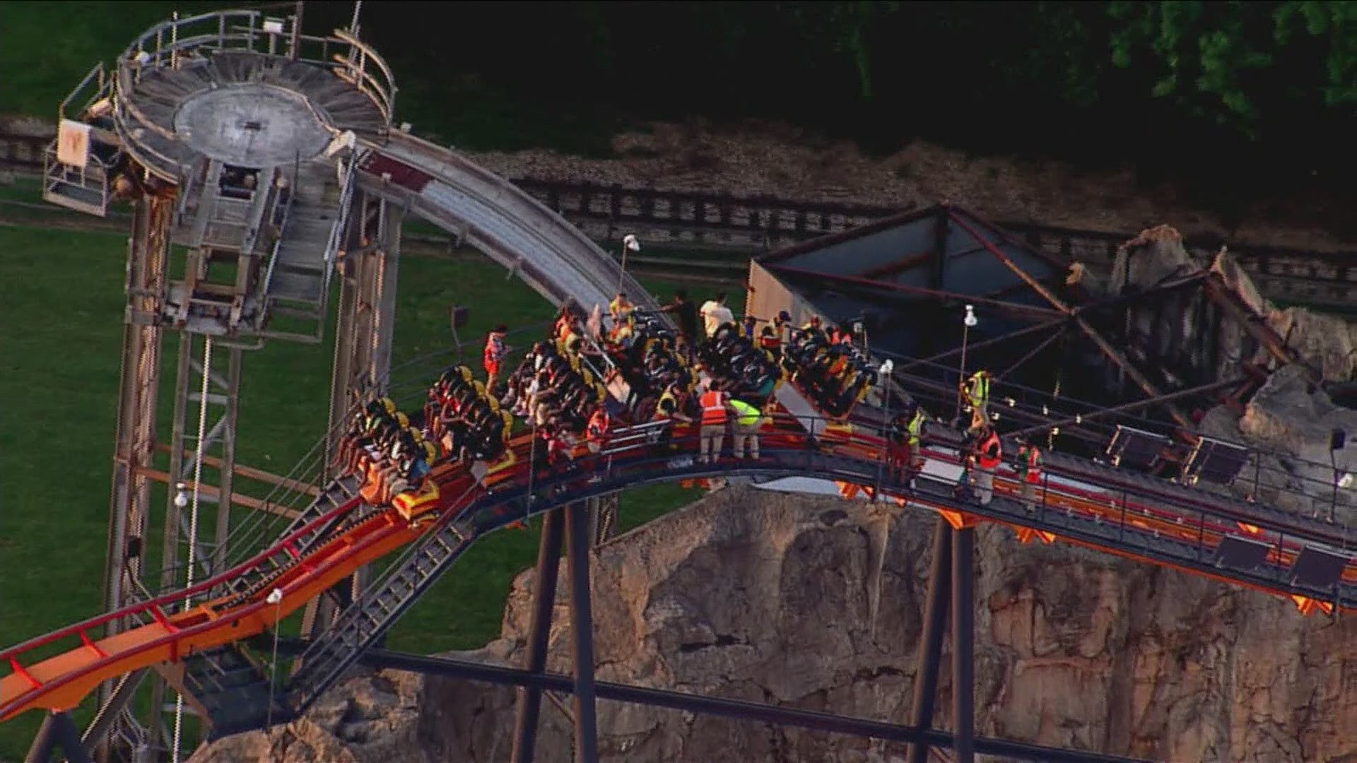 Aerial footage shows workers helping the riders down from the top of the ride.