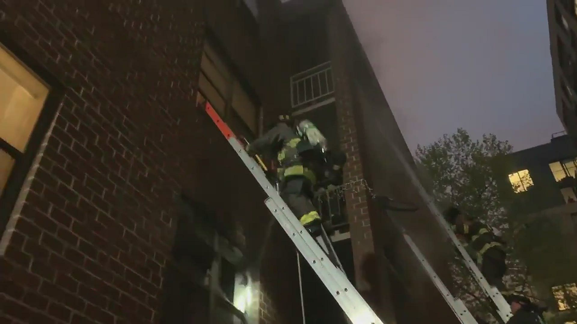 Video shows DC Fire and EMS firefighters attempting to save three people trapped by an apartment building blaze.