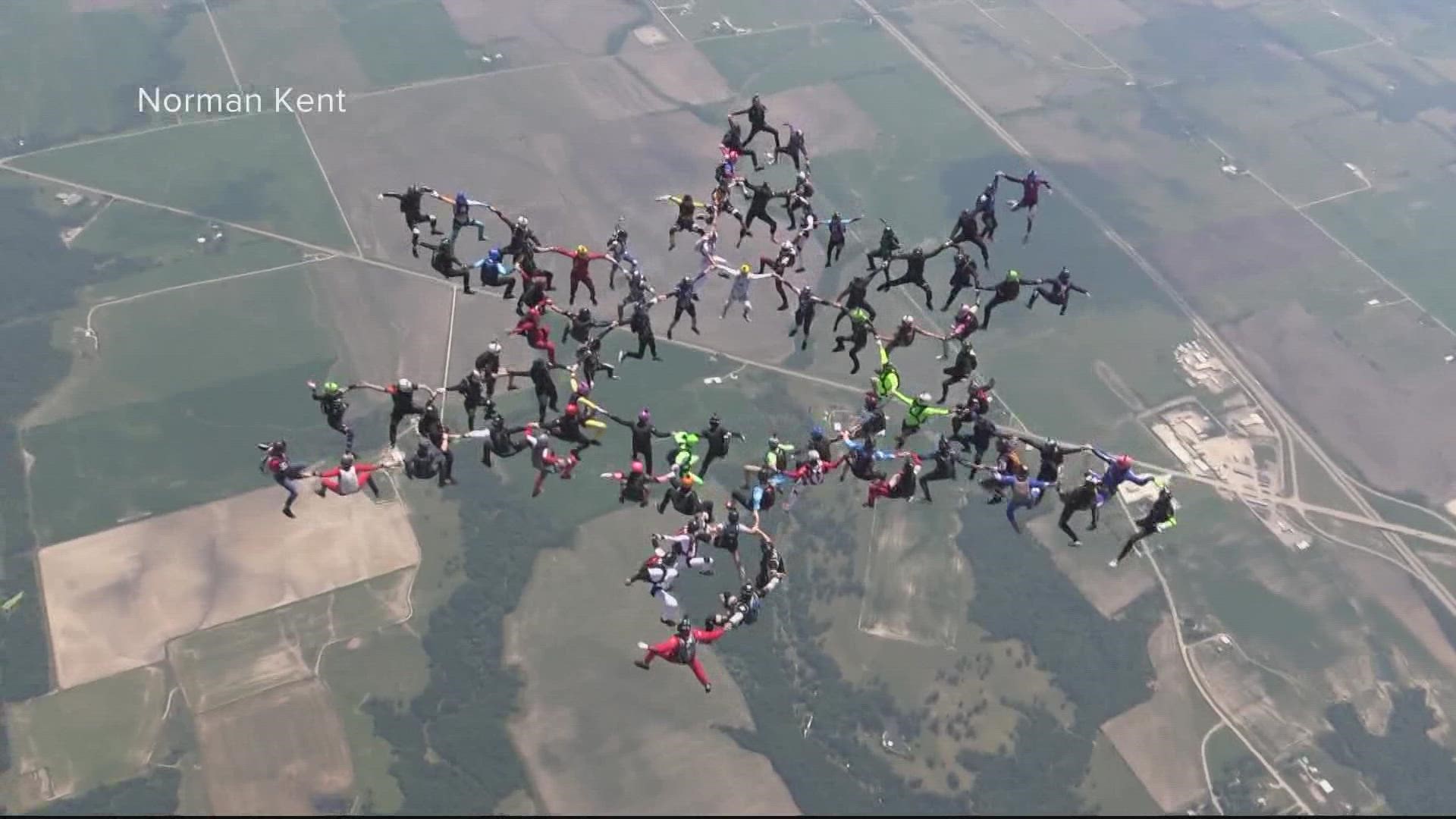 Five planes and 84 skydivers were involved in breaking the record.