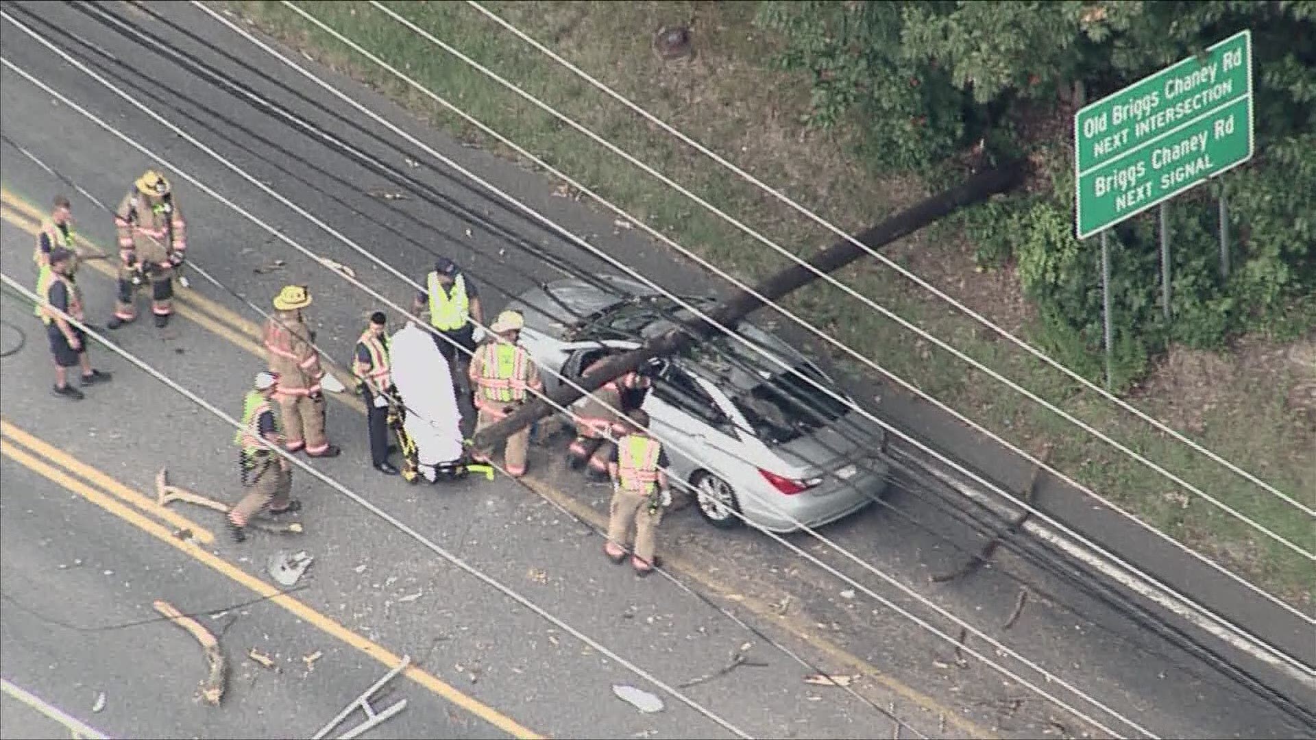 A man was rescued after at least two utility poles fell on his car in Burtonsville, Maryland.